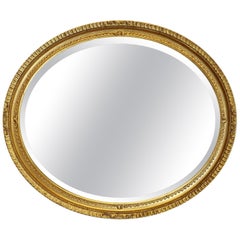 Large French Gilt Oval Mirror  This Mirror has a 2” wide moulded oval frame