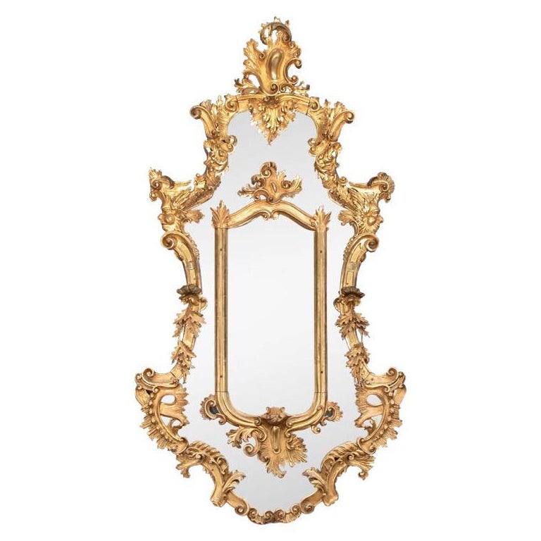 Massive miroir baroque ancien sculpté et doré