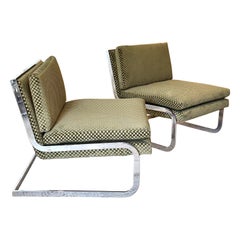 A pair of chrome club chairs with a cantilever design, circa 1960s