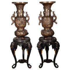 Pair of vases with bases with elephant heads. Bronze, wood, etc. 19th c. etc.