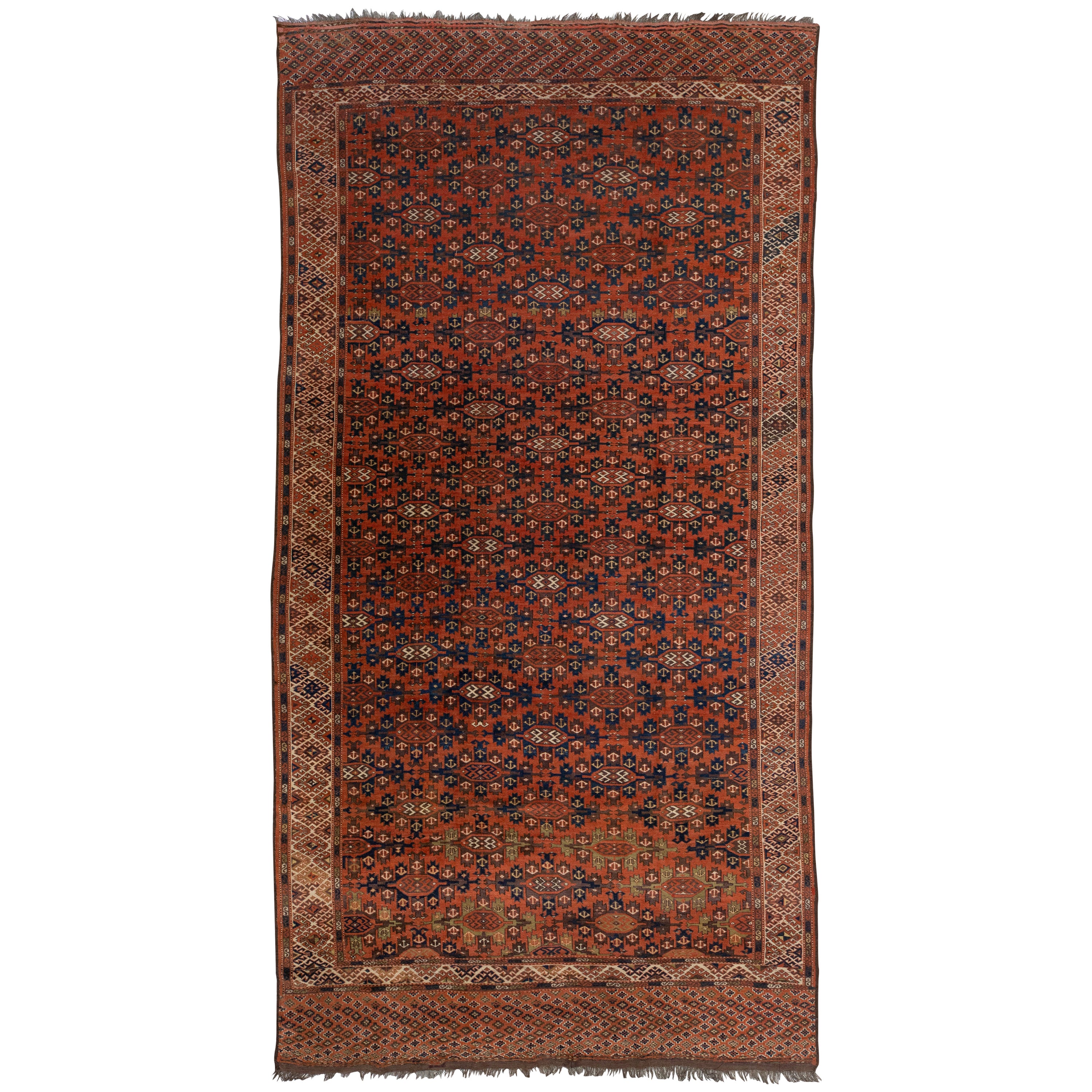Tapis afghan Yamoud ancien fait à la main en laine rouillée avec motif sur toute sa surface en vente