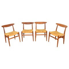 Set Of Four Hans Wegner "W2" Dining Chairs In Solid Oak