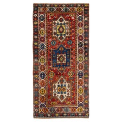 Runner in lana kazaka vintage rosso con disegno geometrico multicolore