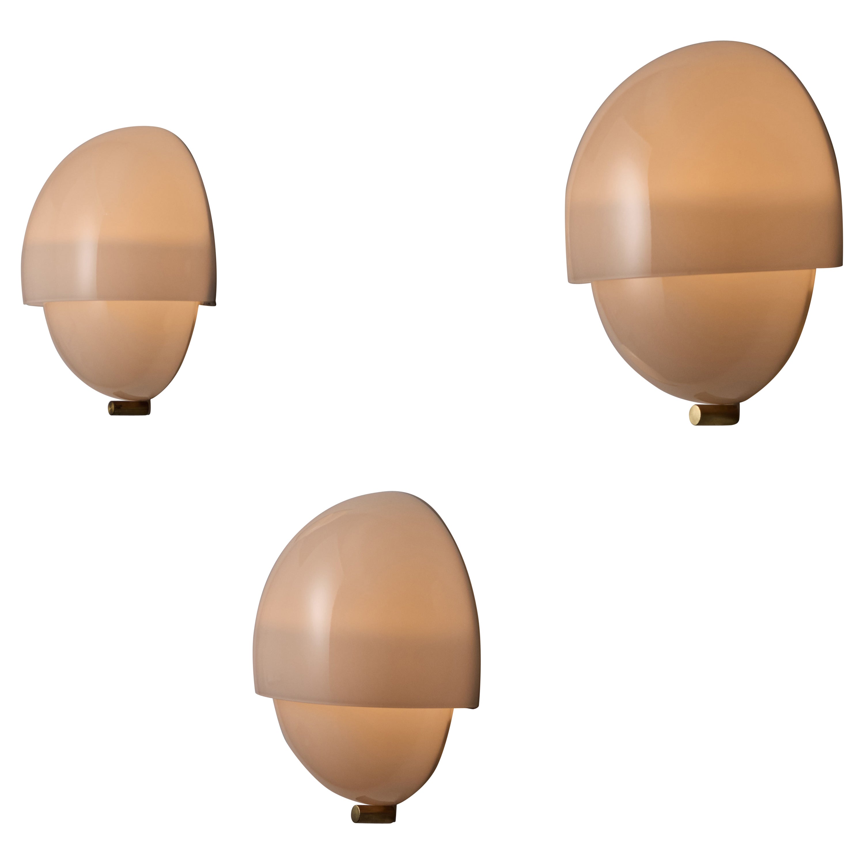 Mania Sconce by Vico Magistretti for Artemide. Designed and manufactured in Italy, circa 1960. Minimal half layered half sphere sconce made from delicate opaline glass. Each sconce holds two E14 socket types, adapted for the US. We recommend using a