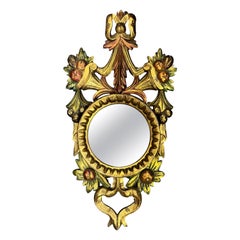 Miroir mural italien du milieu du siècle dernier en bois doré sculpté, peint de fruits et de rubans