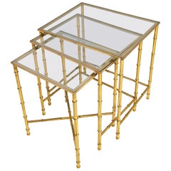 Brass and Glass Three Nesting Tables in the style of Jaques Adnet, France