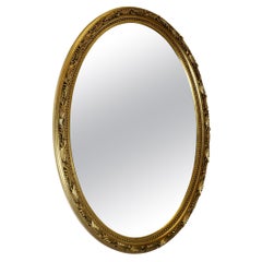Grande specchio ovale decorato e dorato
