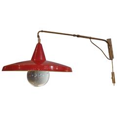 Lumi, an Adjustable Lacquered Aluminum and Brass Wall Light, Italy, 1950