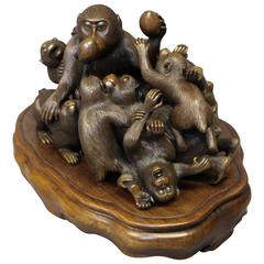 An amusing antique Japanese Bronze of a troop of Monkeys fighting over peaches
