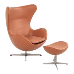1990s Arne Jacobsen for Fritz Hansen Egg Chair w/ Ottoman in New Cognac Leather