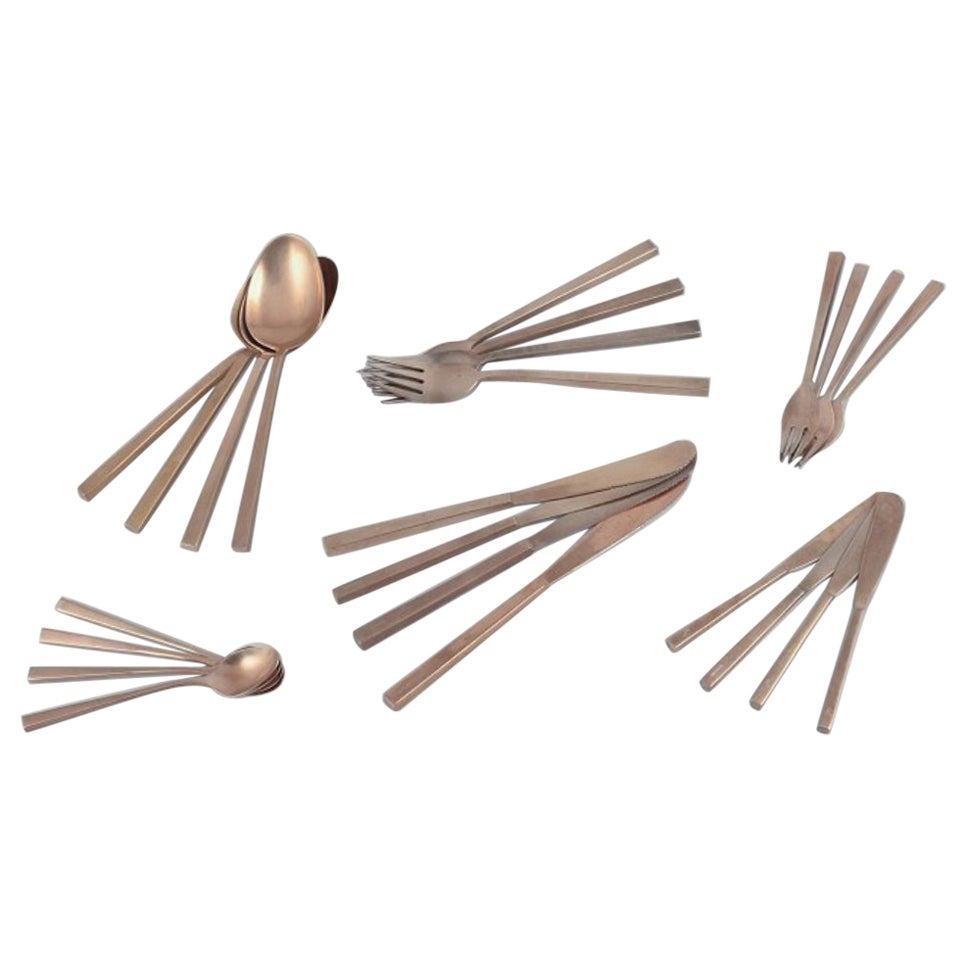'Scanline' brass flatware by Sigvard Bernadotte. Four-person dinner set. For Sale