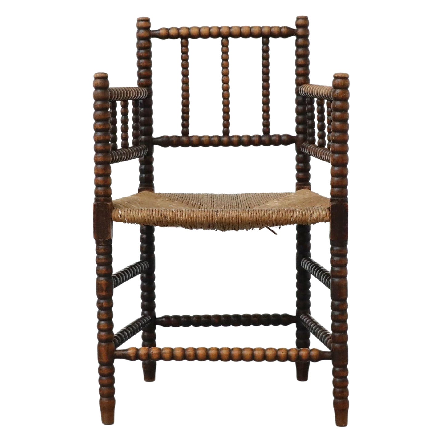Early 20th Century Cottage Style Hand-Carved Wooden Bobbin Chair w/ Rattan Seat