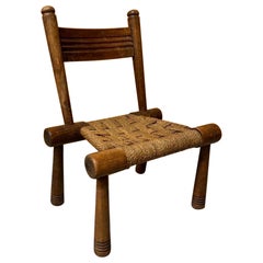A brutalist low chair in oak