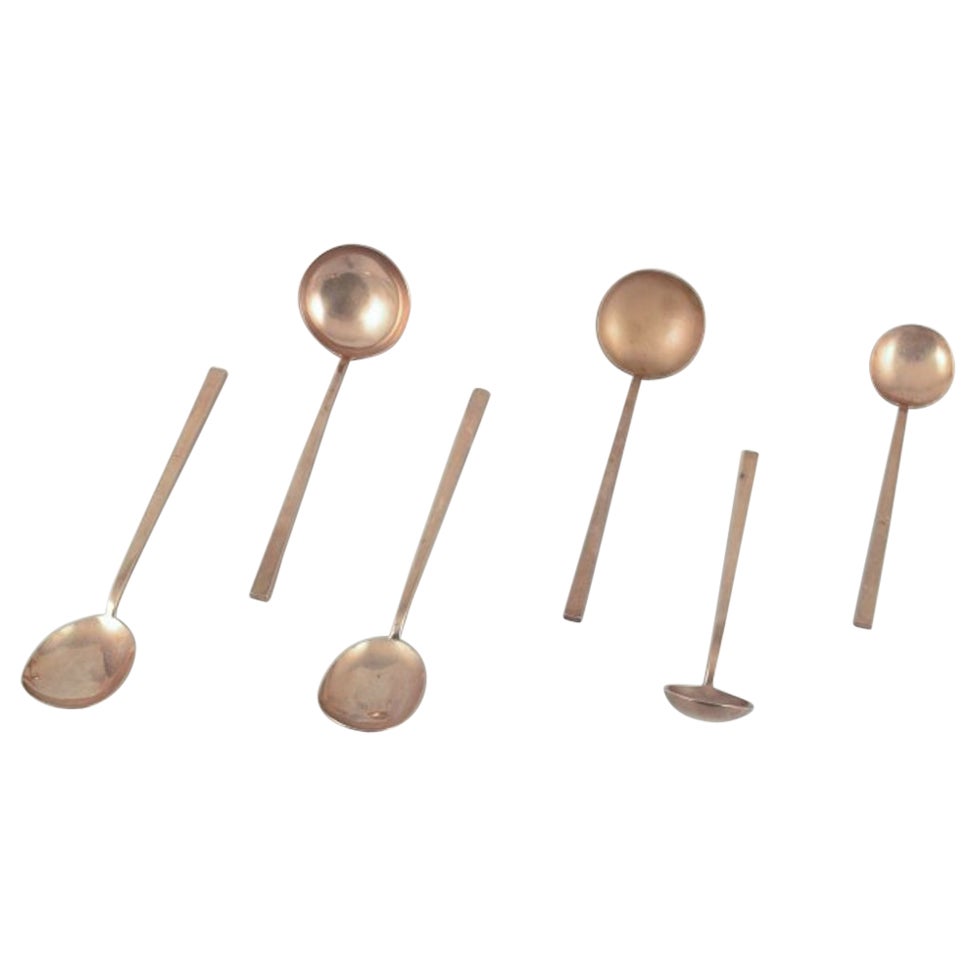 Sigvard Bernadotte "Scanline" brass flatware. Six pieces of serving utensils.