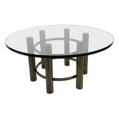 Tavolino da caffè rotondo con piano in vetro e base in bronzo