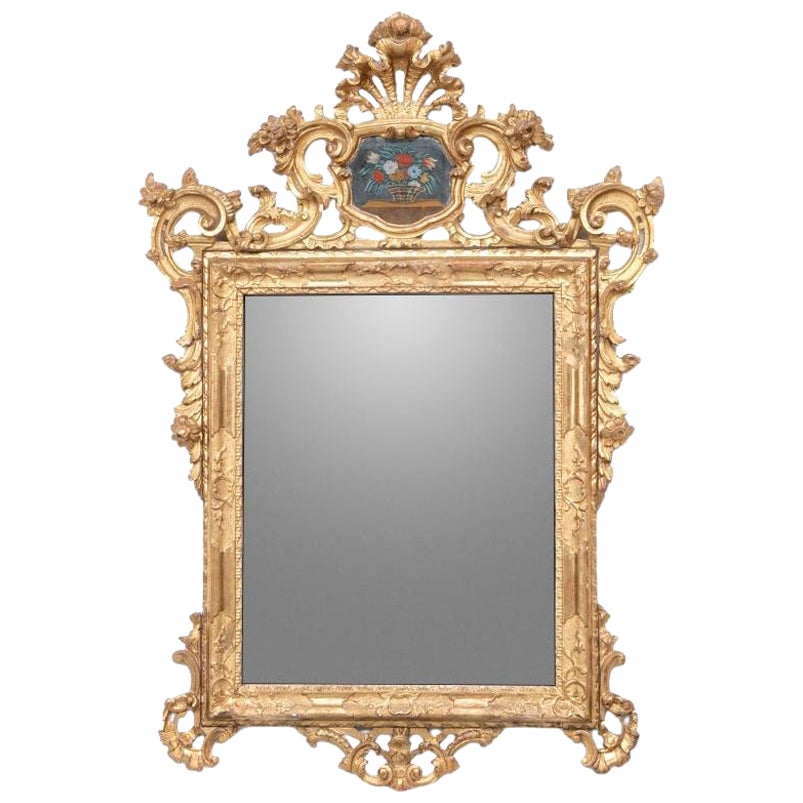 Exceptionnel miroir ancien sculpté, enduit de gesso et doré avec panneau peint