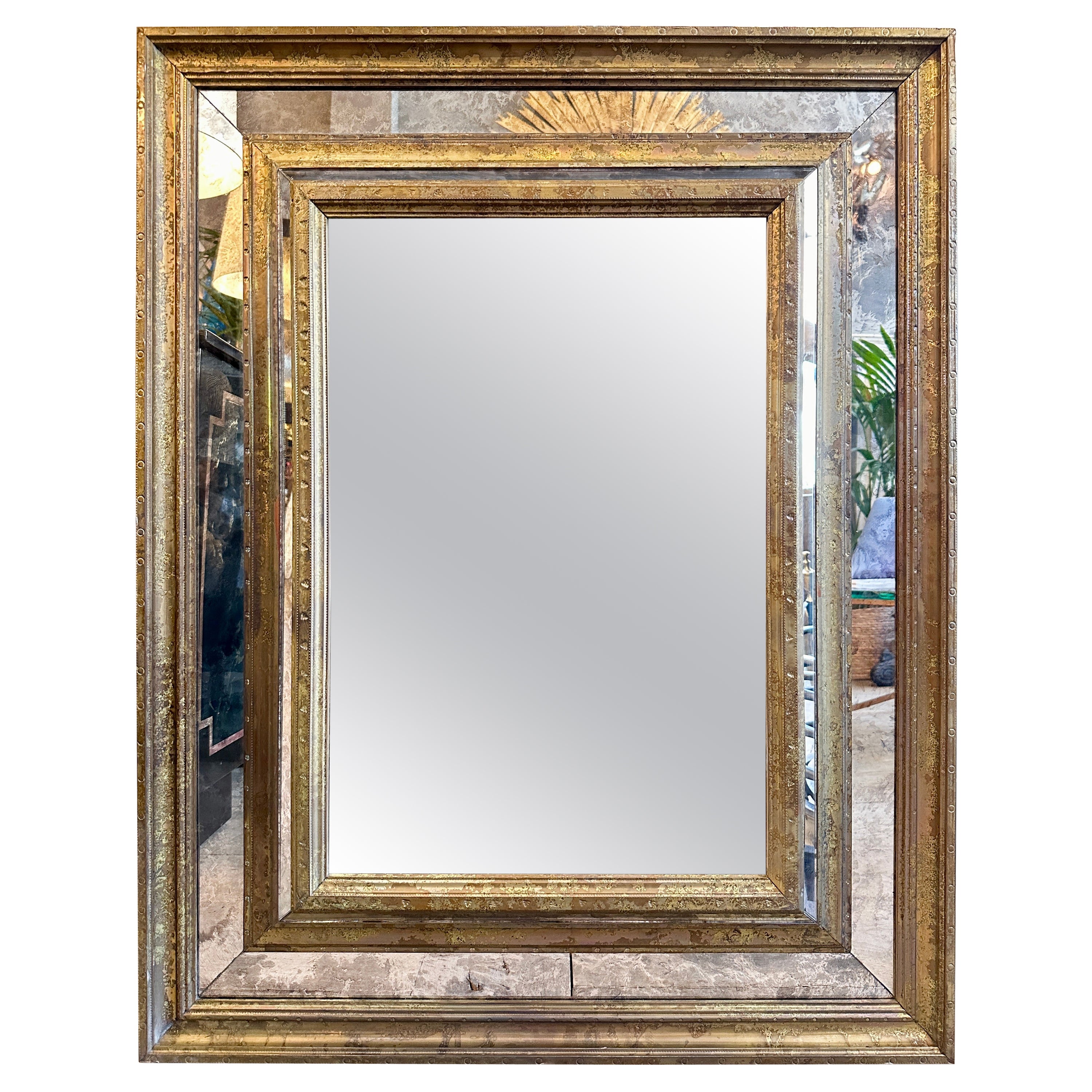 A French Brass Cushion Mirror With Distressed Glass Panels
