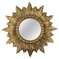 Gold sunburst mirror in resin with convex mirror, France ca. 1960