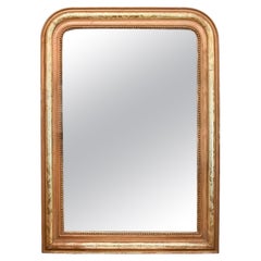 Miroir Louis Philippe doré avec détail de fleurs