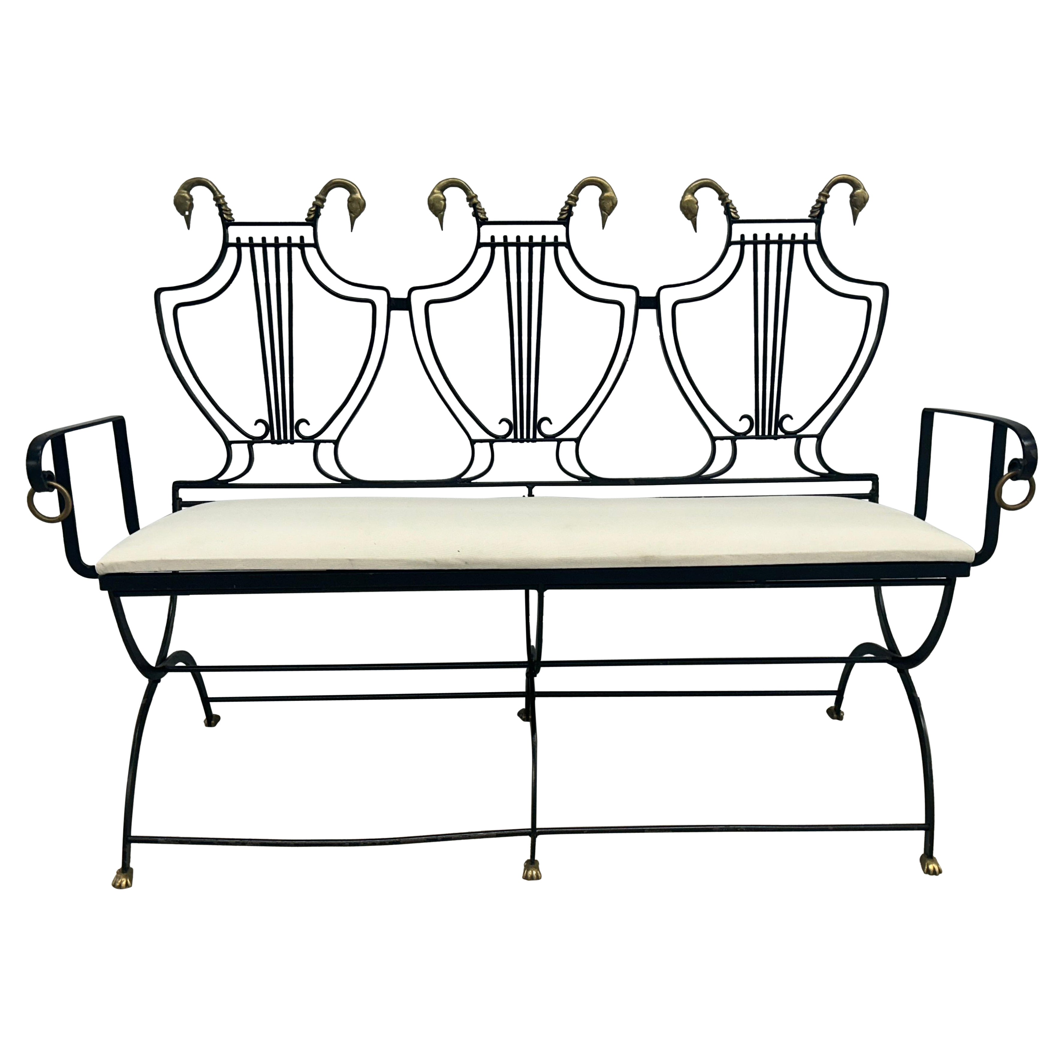 Iron lyre back settee with brass swans heads and paw  feet