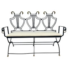 Iron lyre back settee with brass swans heads and paw  feet