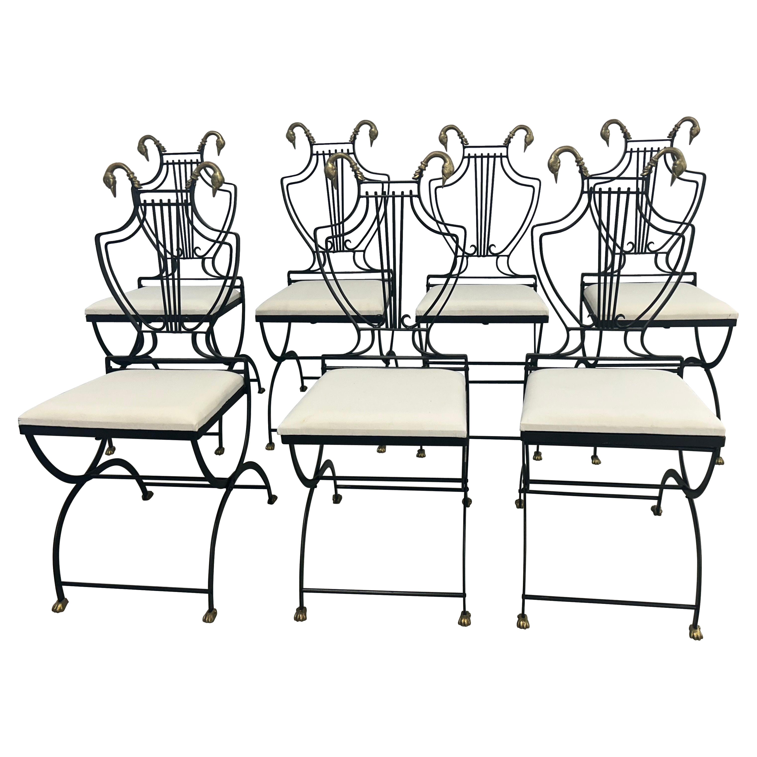 Six Lyre back chairs with brass swan heads and paw feet