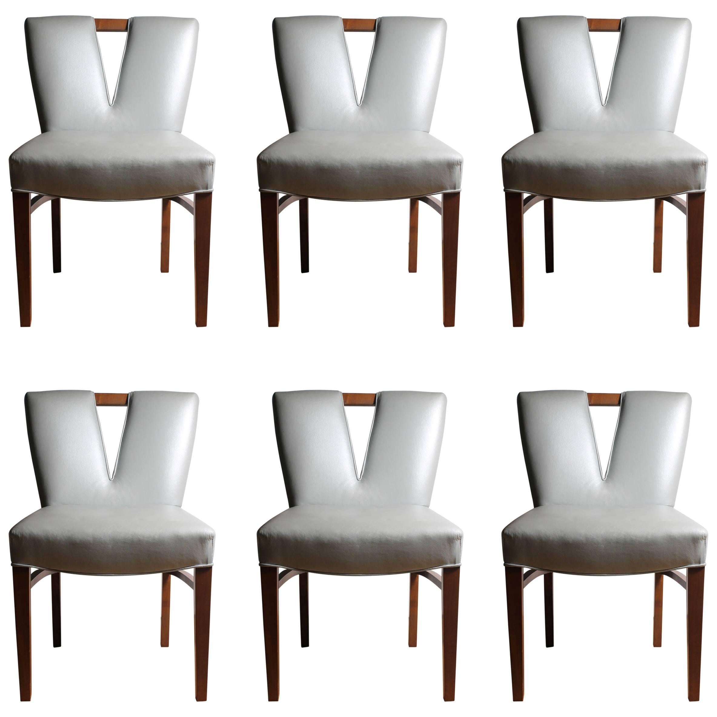 Set of 10 vintage Paul Frankl dining chairs.

2 Armchairs
6 Side Chairs
plus
2 Side Chairs (Once Armchairs - The arms have been removed to appear as side chairs. (Note: The Seat & Back width is slightly wider on these)

10 Chairs