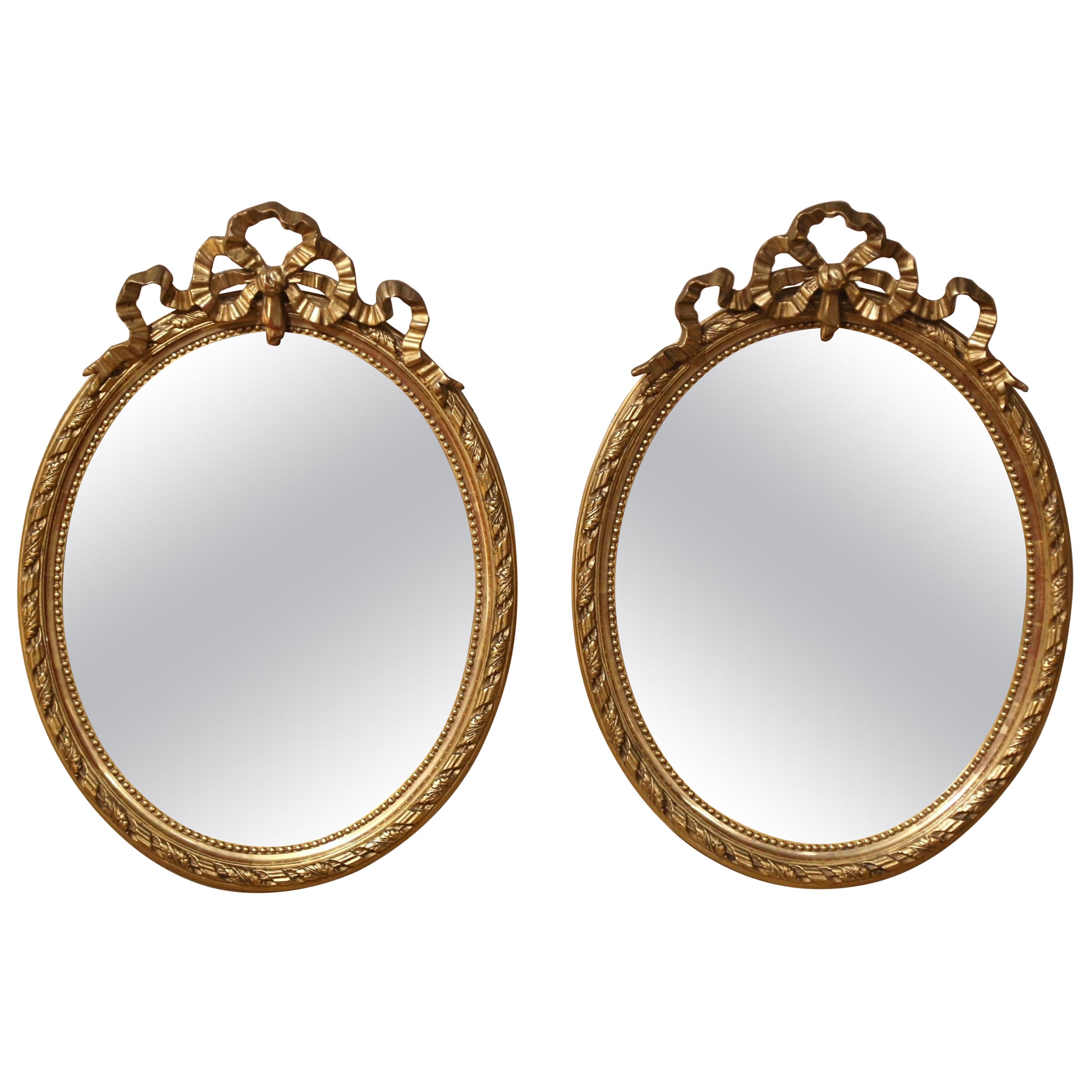 Pair of 19th Century French Louis XVI Carved Giltwood Oval Wall Mirrors