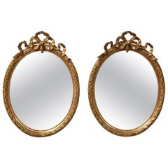 Pair of 19th Century French Louis XVI Carved Giltwood Oval Wall Mirrors