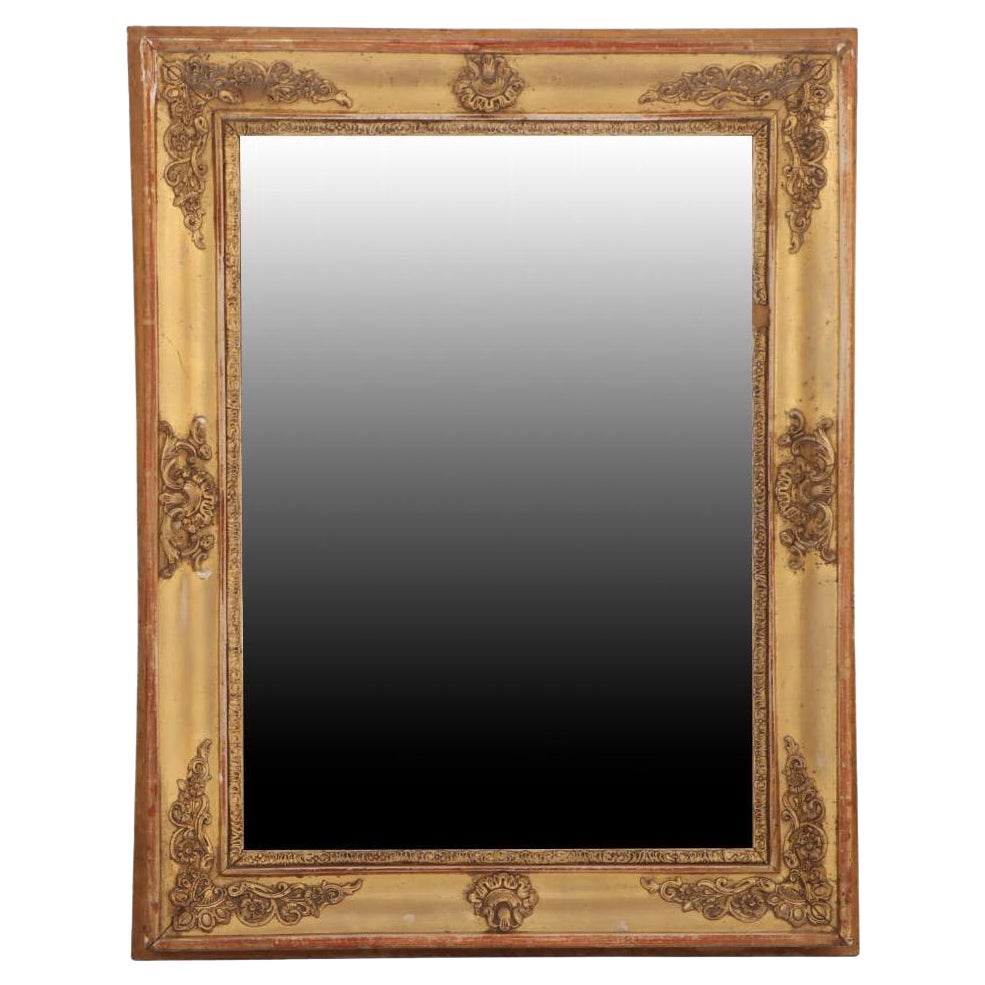 A French Empire small giltwood and gesso decorated mirror, 19th C.