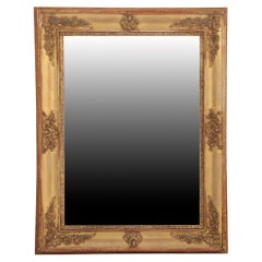 A French Empire small giltwood and gesso decorated mirror, 19th C.