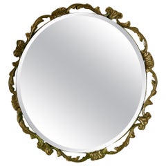 Miroir mural rond Art Déco Atsonea orné de dorures  Le miroir est rond