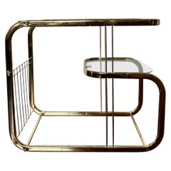 Brass and glass vintage bar cart in the style of Milo Baughman.