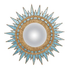 A Dimpled Blue Glass & Resin Convex Sunburst Mirror.
