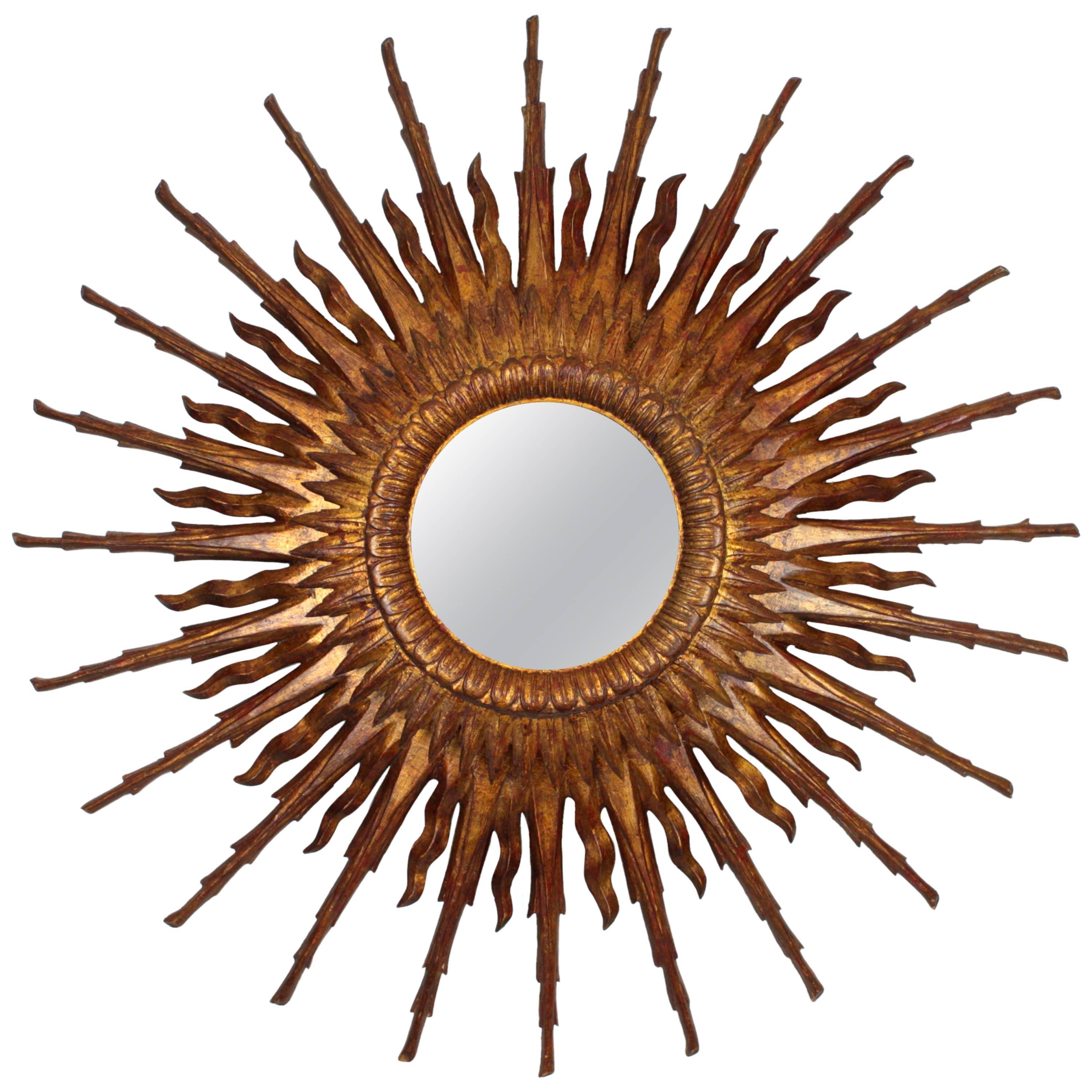 An spectacular giant sized sunburst flush mount or ceiling light fixture in Baroque style made in Spain at the Mid-20th century. Unusual extra large size with two layers of beams in different sizes that make this piece gorgeous and highly decorative