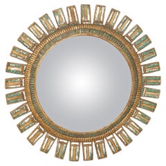 A large green glass and resin convex sunburst mirror.