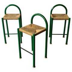 Set of three bar stools in green metal and rush seats, 1970’s Italy