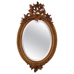Antique French Oval Shaped Gold-Leaf Framed Mirror with Beveling, Circa 1895.