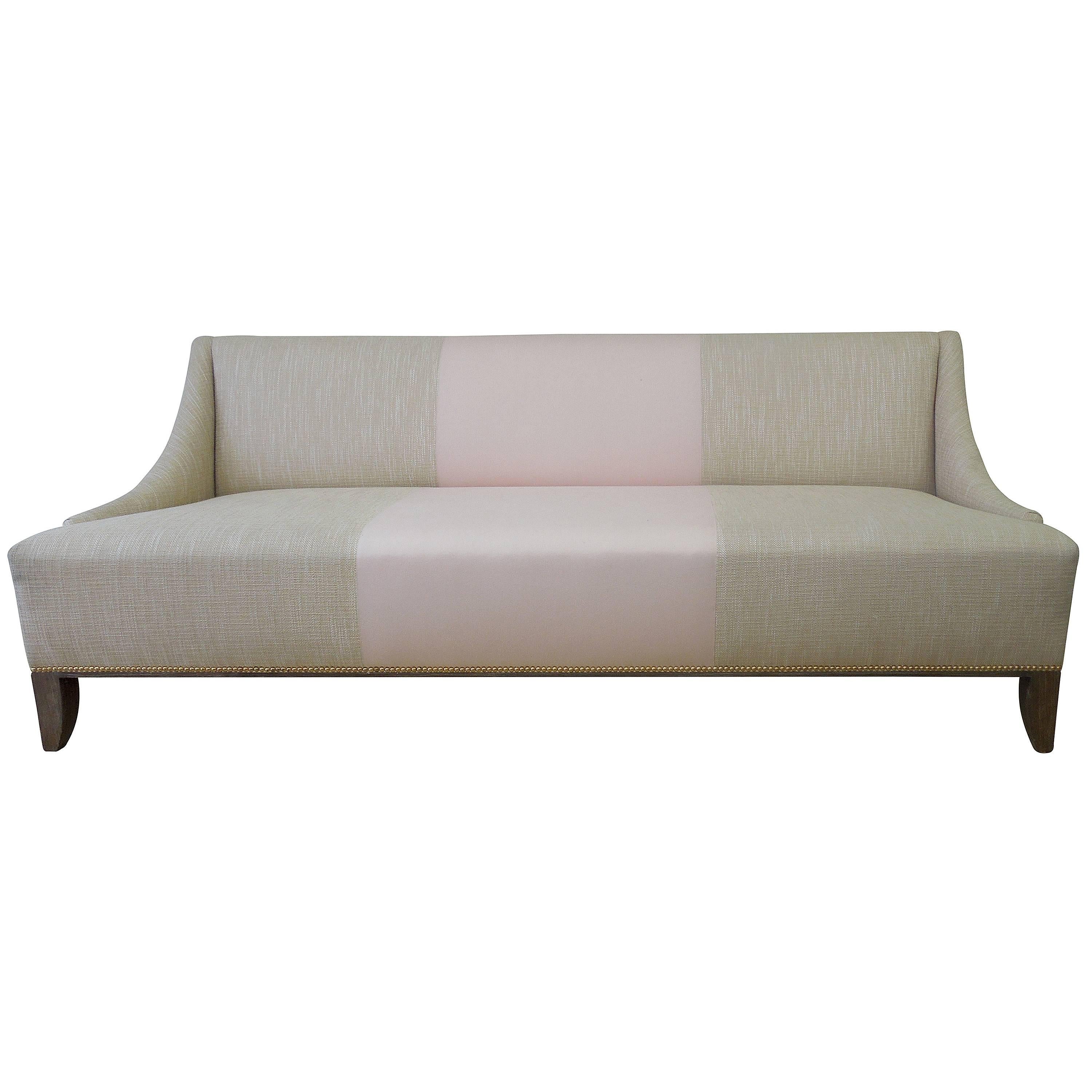 A custom-made modern tan linen and fashionista pink wool-blend sofa. Handmade in Los Angeles for designer residence. Brass nailhead trim. Beautiful grey or brown feet. Modern and very chic!
