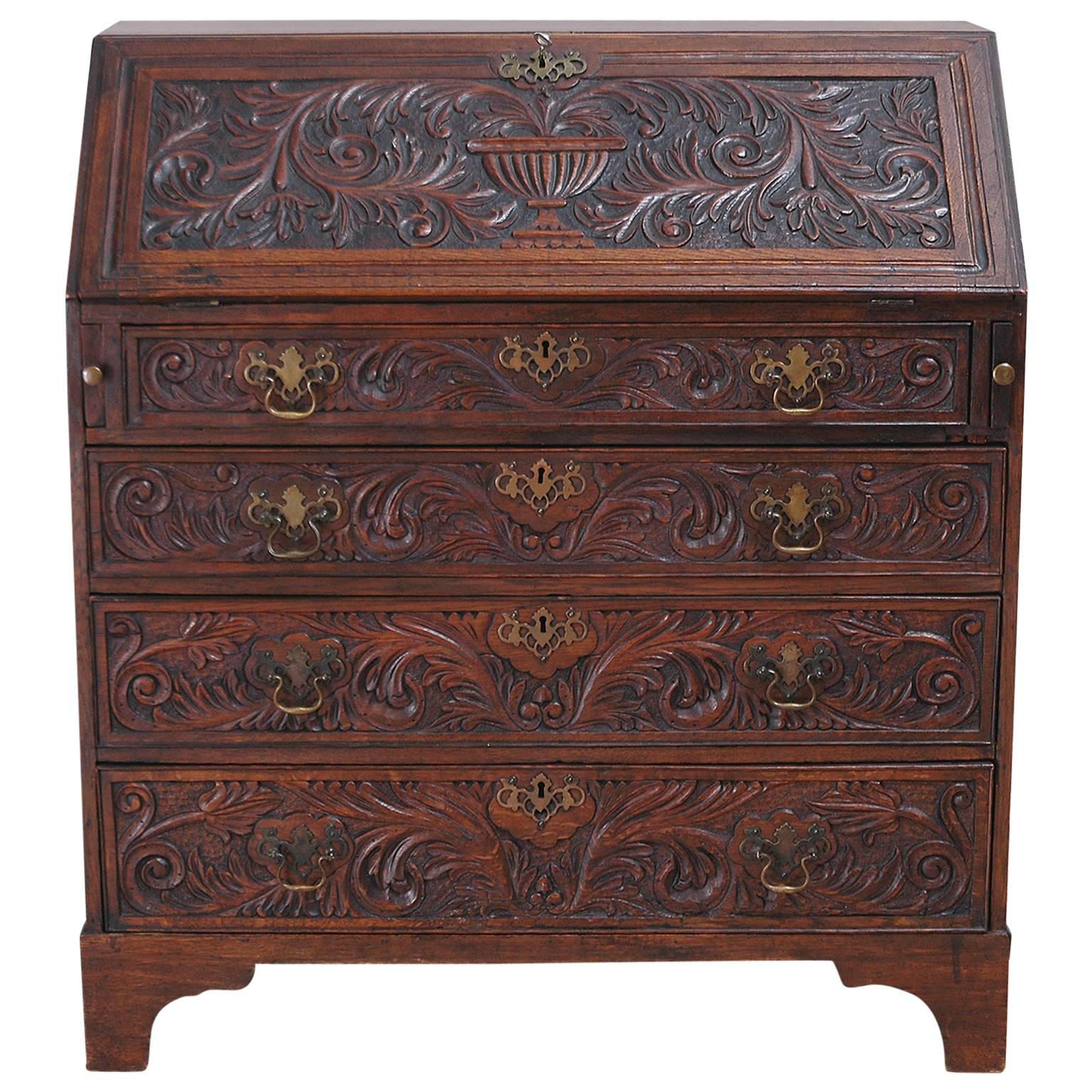 Early 19th century oak English fall-front secretary with carvings of acanthus leaves and urns.
Note: Relaxed, antique condition. Drawers are working well and original brasses are complete.
You should always request a shipping quote.
Quoted amounts