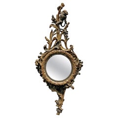 Specchio decorativo francese in legno intagliato, inizio XIX secolo.