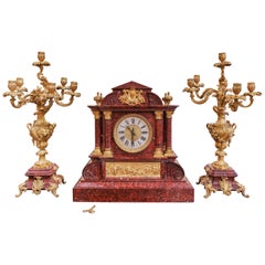 A fine 19th century French red marble and gilt bronze clock set