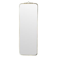 An orignal Italian 1950s brass framed mirror with scroll top detail