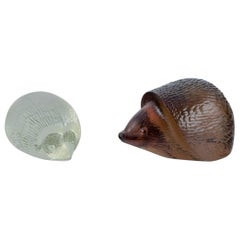 Paul Hoff for Kosta Boda and an unknown Swedish glass artist. Two hedgehogs.