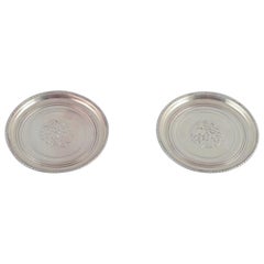 Georg Jensen, two bottle coasters in sterling silver.