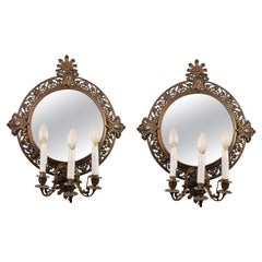 Pair of mirrors with appliqués. Metal, glass. 20th  century.