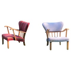 A pair of curved armchairs in solid oak from the 1940s.
