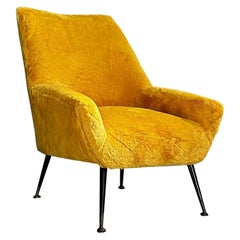 Mid-Century Modern Italian armchair, brass feet and soft ochher-yellow fabric