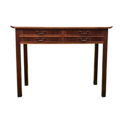 Freestanding nutwood small desk with brass “shoes”. Top with raised edges.