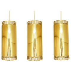 Set of 3 perforated brass cylindrical pendant lamps, Sweden 1960's
